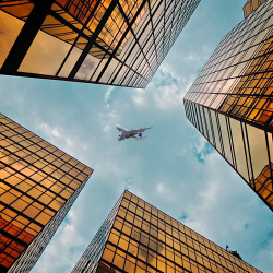 Buildings with a plane flying over head indicating phobias that can be treated at MB-Hypnotherapy